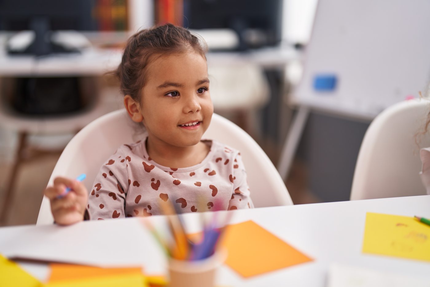A girl drawing at the art table