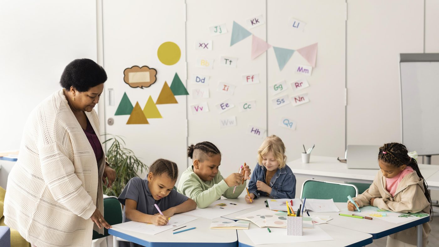 Preschoolers drawing together at a table
